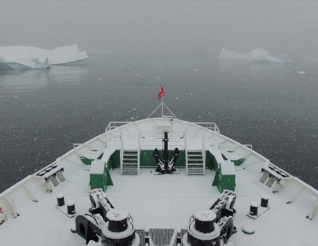 Research vessel with icebergs in forward view